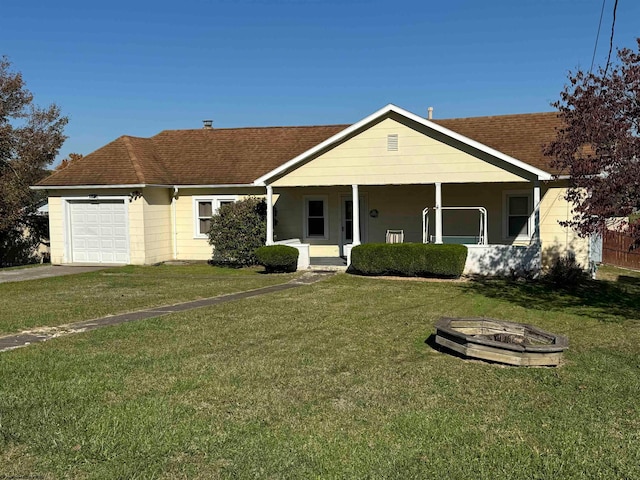 single story home with a front yard, covered porch, and a garage