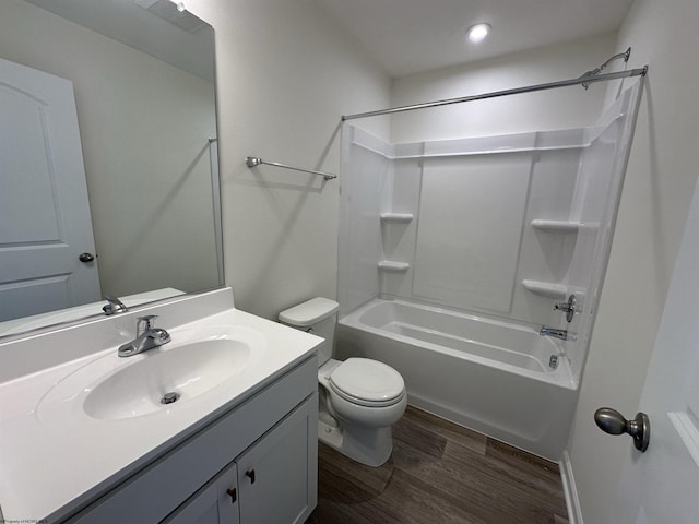 full bathroom featuring hardwood / wood-style floors, vanity, toilet, and tub / shower combination