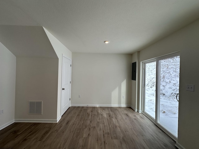 spare room with hardwood / wood-style flooring and a textured ceiling