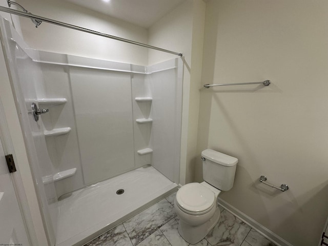 bathroom featuring toilet and a shower