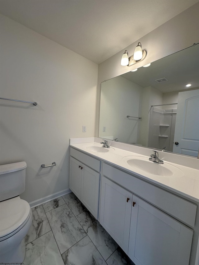 bathroom with a shower, vanity, and toilet