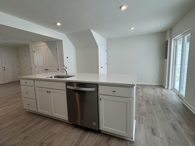 kitchen featuring white cabinetry, dishwasher, a center island with sink, and sink