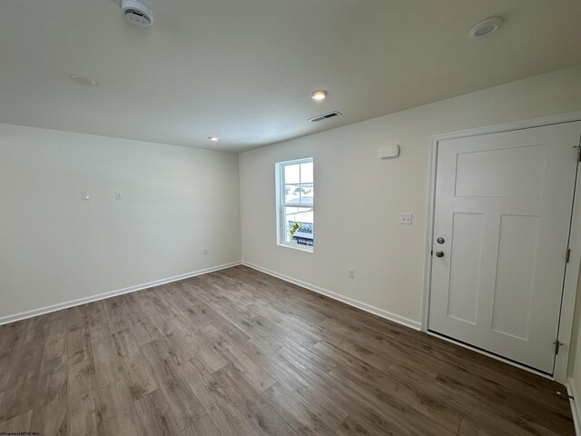 unfurnished room with hardwood / wood-style floors