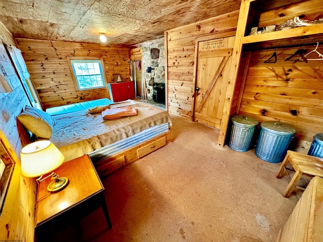 bedroom featuring wooden walls and carpet flooring