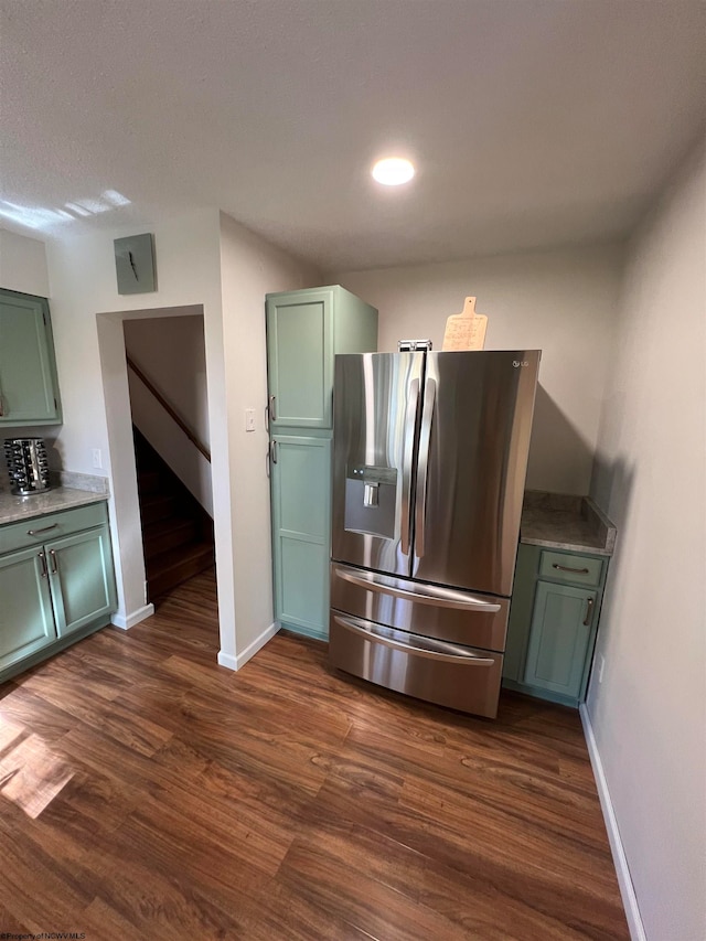 kitchen with green cabinets, stainless steel fridge with ice dispenser, and dark hardwood / wood-style flooring