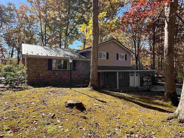 rear view of property with a lawn