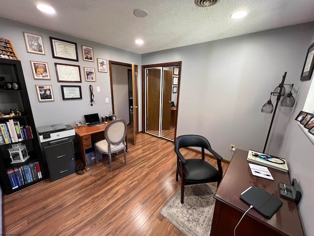 office with a textured ceiling and hardwood / wood-style floors