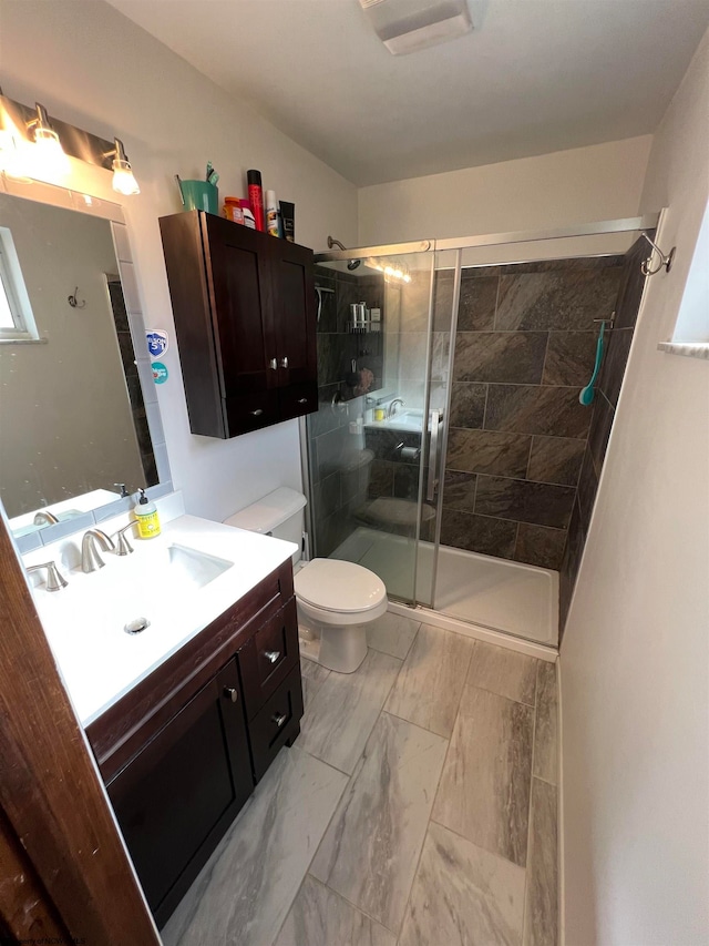 bathroom with vanity, toilet, and walk in shower