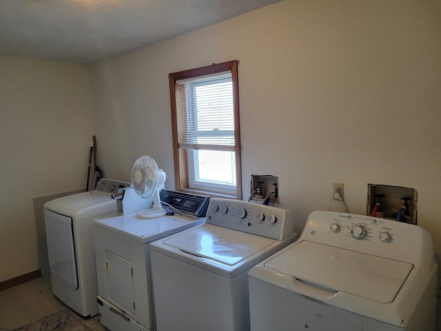 clothes washing area featuring a textured ceiling and separate washer and dryer