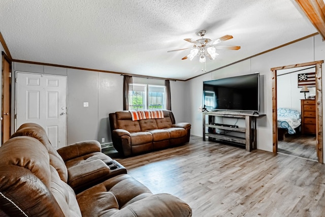 living room with ornamental molding, light wood-style flooring, a ceiling fan, and lofted ceiling