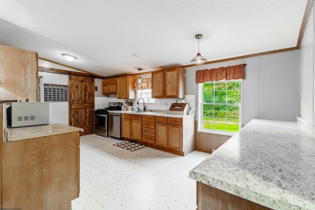 kitchen with brown cabinetry, decorative light fixtures, vaulted ceiling, light countertops, and stainless steel appliances