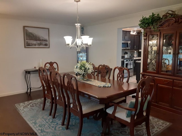 dining space with a notable chandelier and ornamental molding