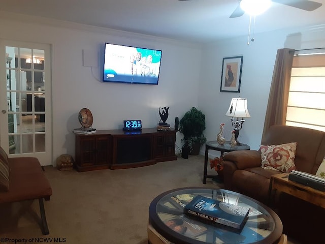 carpeted living room with ceiling fan