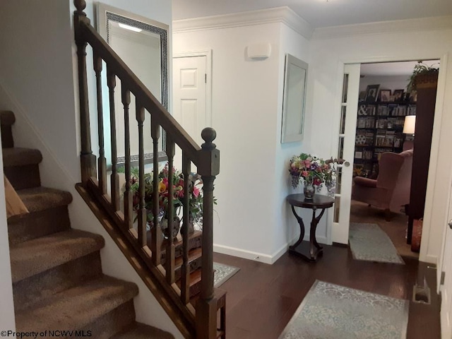 stairs with crown molding and wood-type flooring