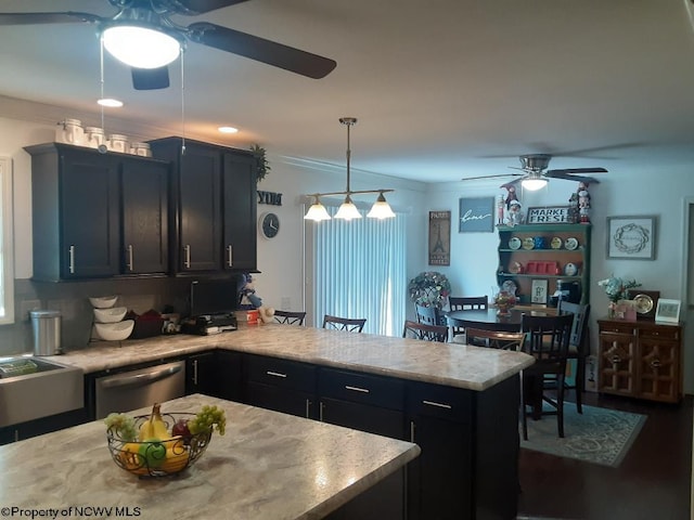 kitchen featuring kitchen peninsula, ceiling fan, decorative light fixtures, stainless steel dishwasher, and ornamental molding