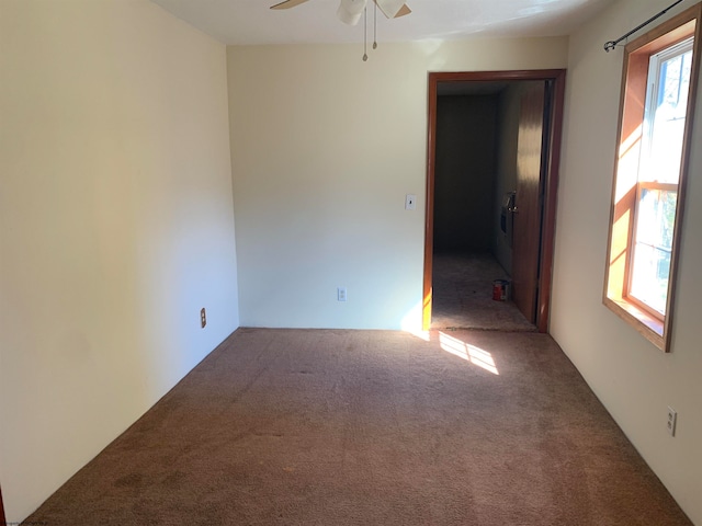 carpeted empty room featuring ceiling fan