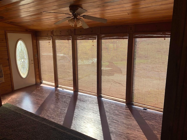 unfurnished sunroom featuring wooden ceiling and ceiling fan