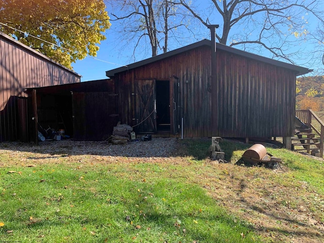 view of outbuilding with a yard