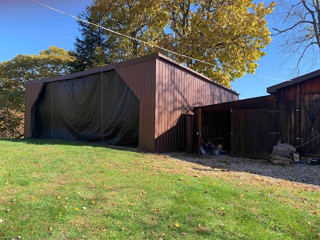 view of outbuilding with a yard