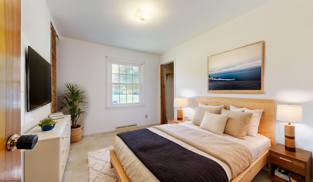 carpeted bedroom with a baseboard heating unit