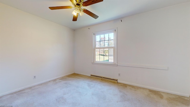 spare room featuring baseboard heating, light carpet, and ceiling fan