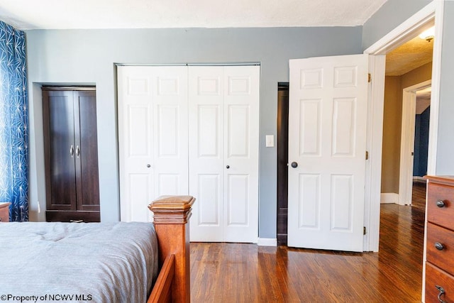 bedroom featuring a closet and dark hardwood / wood-style floors