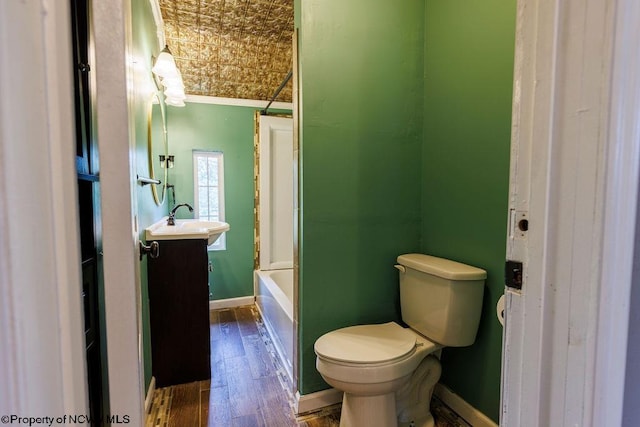 full bathroom featuring toilet, shower / bathing tub combination, wood-type flooring, crown molding, and vanity