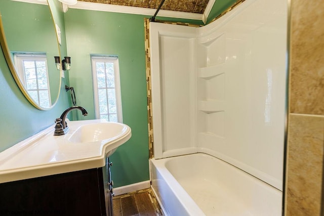 bathroom featuring vanity, crown molding, tub / shower combination, and hardwood / wood-style floors