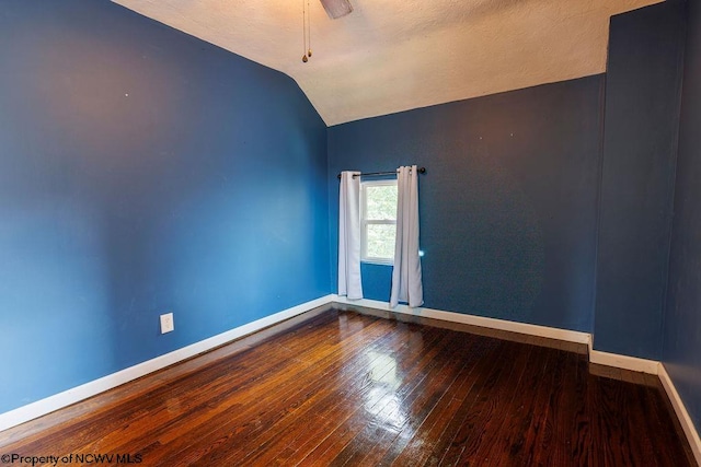 spare room featuring hardwood / wood-style floors, vaulted ceiling, and ceiling fan