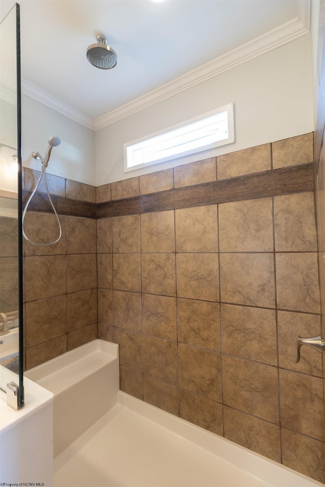 bathroom with tiled shower and ornamental molding