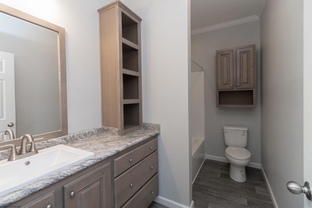 full bathroom with hardwood / wood-style flooring, toilet, ornamental molding, vanity, and bathing tub / shower combination