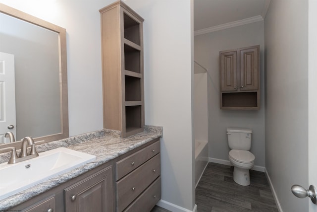 bathroom with baseboards, ornamental molding, toilet, and vanity
