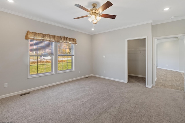 unfurnished bedroom with light carpet, ornamental molding, and ceiling fan