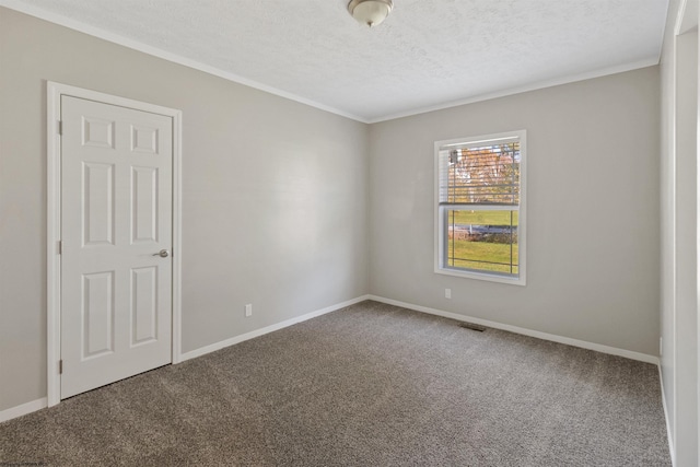 unfurnished room featuring carpet and a textured ceiling