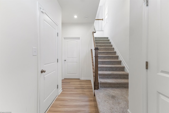 stairs featuring hardwood / wood-style flooring