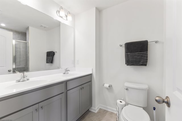 bathroom featuring vanity, toilet, tile patterned floors, and walk in shower