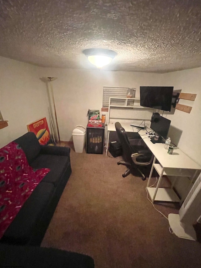 home office featuring a textured ceiling and carpet floors