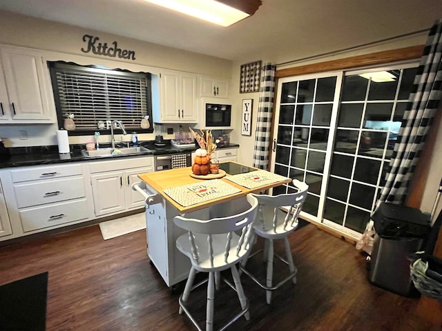 kitchen with dark hardwood / wood-style flooring, white cabinetry, and sink