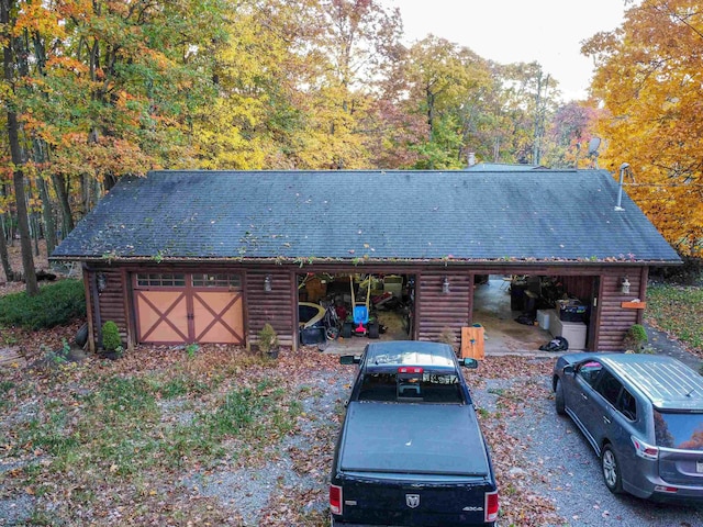 log cabin featuring an outbuilding and a garage