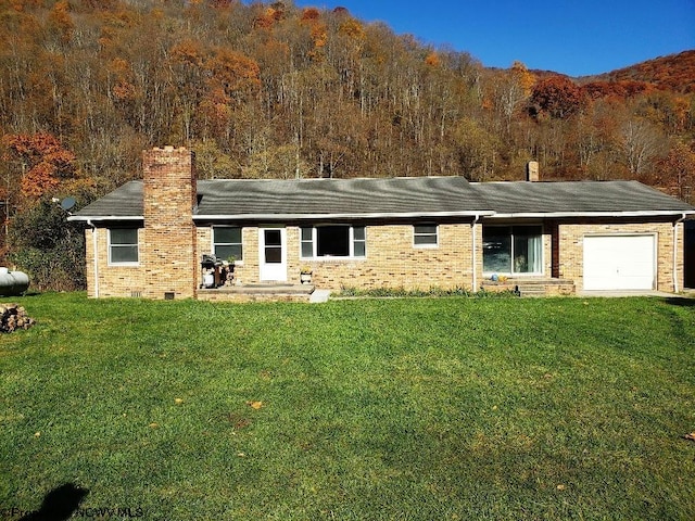 view of front facade with a front yard and a garage