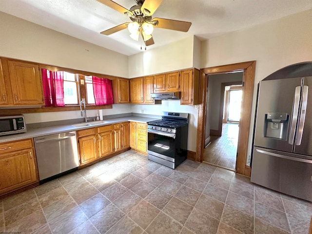 kitchen featuring ceiling fan, stainless steel appliances, and sink