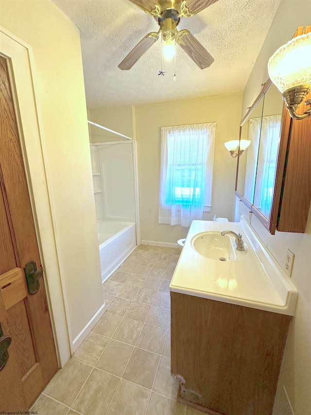 bathroom with washtub / shower combination, a textured ceiling, ceiling fan, tile patterned floors, and vanity