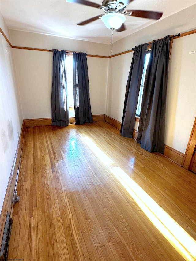 unfurnished room with hardwood / wood-style floors and ceiling fan