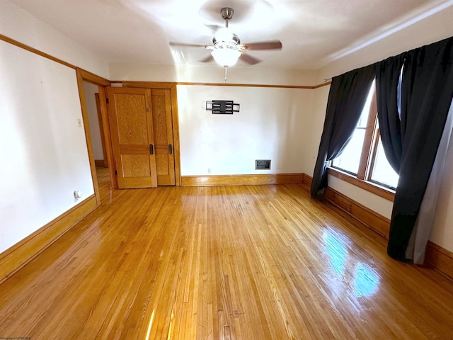 unfurnished room featuring light hardwood / wood-style flooring and ceiling fan