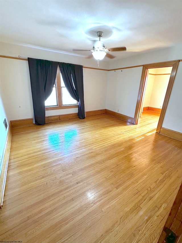 unfurnished room with ceiling fan and light wood-type flooring