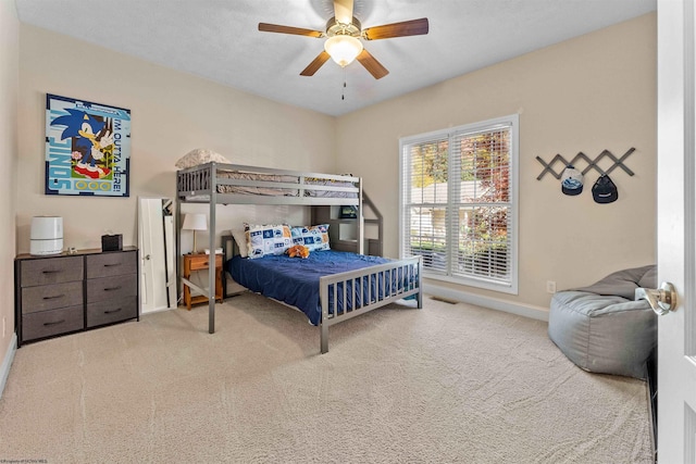 bedroom with light carpet, a textured ceiling, and ceiling fan