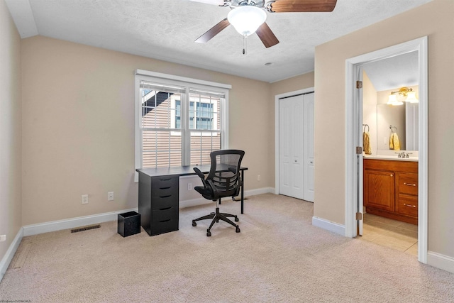 office with sink, a textured ceiling, ceiling fan, vaulted ceiling, and light colored carpet