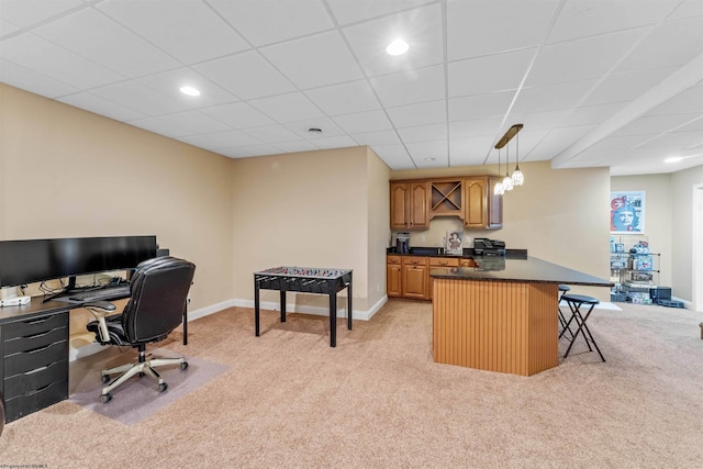 interior space featuring a kitchen bar, light carpet, kitchen peninsula, and pendant lighting