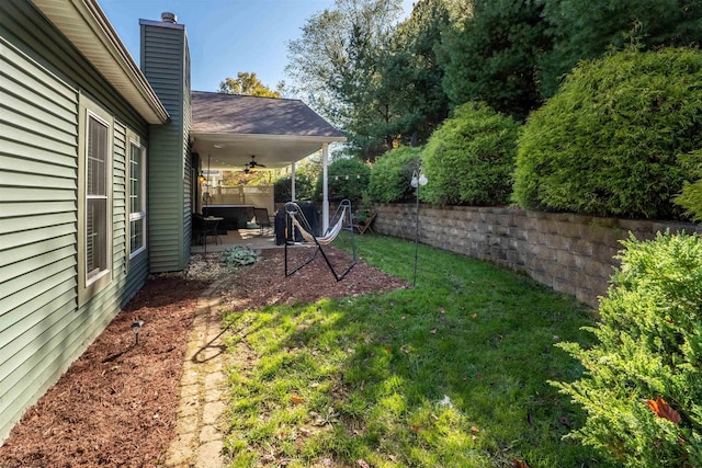 view of yard featuring a patio and ceiling fan