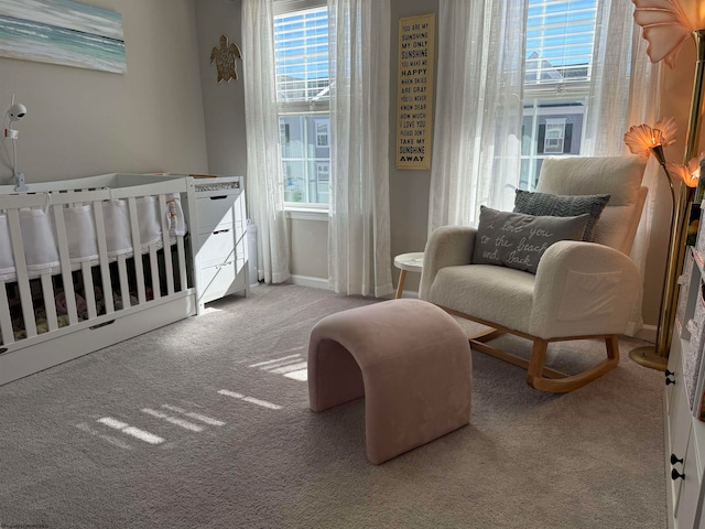 bedroom featuring light carpet and a crib